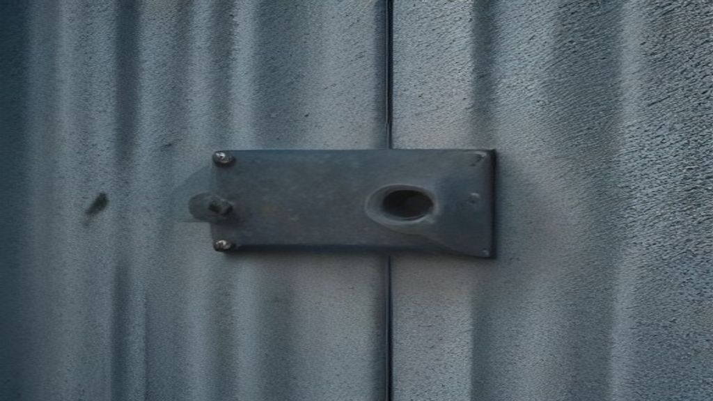Weathered metal panel fasteners and a ribbed seam on an exposed wall.